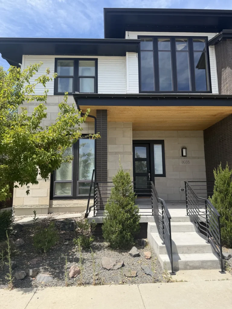 Modern Colorado home exterior with black windows and warm wood soffit
