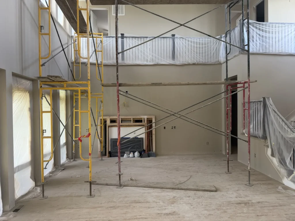 Protected interior with scaffolding during a whole-home remodeling project